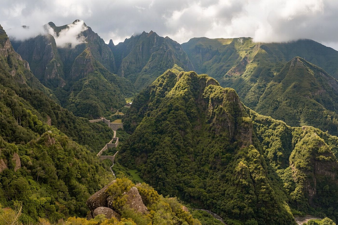 A wide panoramic view looking down into the deep valley of Curral das Freiras from the Eira do Serrado viewpoint.