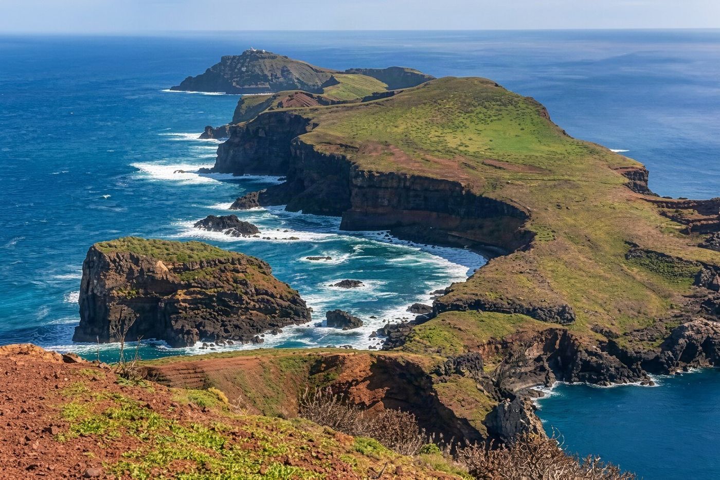 A sweeping landscape view of the rocky eastern peninsula under a cloudy sky.